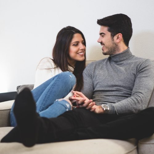 couple-sitting-gray-couch