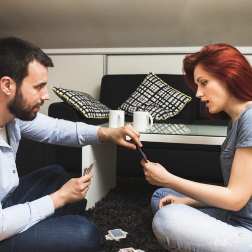 young-couple-playing-cards-home